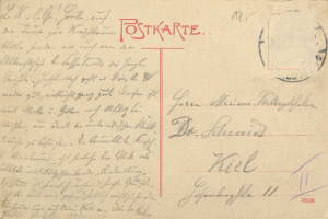 Eine alte Postkarte aus Deutschland mit einem roten Stempel und handgeschriebener Schrift, wahrscheinlich ein Brief von der deutschen Regierung.