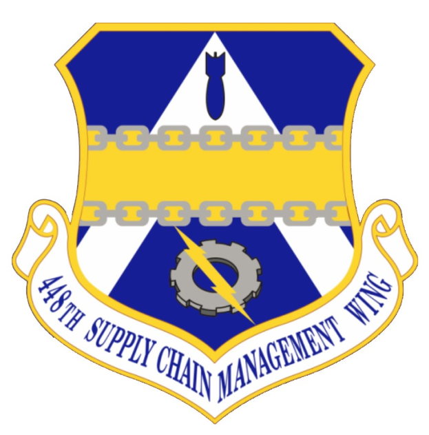 Logo des 48. Versorgungsgeschwader mit einem blauen Schild, einem weißen Stern, einem weißen Banner mit der Aufschrift "Versorgungsgeschwader" in blau und dem Text "48. Versorgungsgeschwader" in fetter schwarzer Schrift.