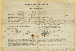 Altes deutsches Regierungsdokument mit einem kreisförmigen, schwarz umrandeten Stempel auf vergilbtem Papier, das schwarze Schrift enthält.